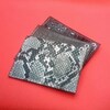 新作です。カードケース(定期入れ)  今回は全て爬虫類系の合成皮革を使用。  蛇革(パイソン)      ワニ革(クロコブラウン)    ワニ革(クロコブラック)    裏側と表側にそれぞれポケットを。  シンプルイズベスト！この形が1番コンパクトで使い易い？どの革目がお好みでしょう？