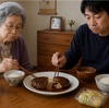 レトルトのハンバーグを半分ずつ食べる母子