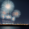 舞洲から見上げた、万博の夜空に咲く花火と大屋根リングの幻想的な光