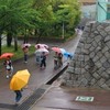 五月雨に傘さし登校する子供達